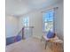 Bright loft area with chair, decor, and railing overlooking the staircase at 215 Shortmarsh St, Summerville, SC 29486