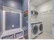 Mud room with blue accent wall, a hall tree, and a white washer and dryer set at 215 Shortmarsh St, Summerville, SC 29486