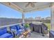 Relaxing covered patio with comfortable seating, ceiling fan, and grill, perfect for outdoor entertaining at 215 Shortmarsh St, Summerville, SC 29486