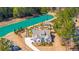 Aerial view of the property showcasing landscaping, a lush garden, and a vibrant lake at 225 Camber Rd, Huger, SC 29450