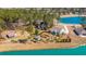 Expansive aerial view of the property showcasing a vibrant lake, landscaped garden, and a cozy home at 225 Camber Rd, Huger, SC 29450