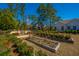 Expansive backyard features garden, terraced landscaping, mature trees, and charming single-Gathering home at 225 Camber Rd, Huger, SC 29450
