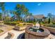 Picturesque backyard featuring lush landscaping, a fountain, and a pathway leading to the home at 225 Camber Rd, Huger, SC 29450