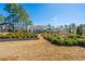 Picture of an expansive landscaped backyard featuring a garden and mature trees under a clear sky at 225 Camber Rd, Huger, SC 29450