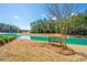 Serene backyard view featuring a bench overlooking a beautiful pond surrounded by trees at 225 Camber Rd, Huger, SC 29450