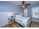 Cozy bedroom with paneled walls, wood floors, and plenty of natural light at 225 Camber Rd, Huger, SC 29450