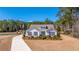 Charming home with a well-manicured lawn, a long driveway, and serene water views at 225 Camber Rd, Huger, SC 29450