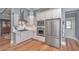Bright kitchen features stainless steel appliances, white cabinets and granite countertops at 225 Camber Rd, Huger, SC 29450