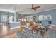 Spacious living room featuring hardwood floors, ceiling fan, and open to dining and kitchen areas at 225 Camber Rd, Huger, SC 29450