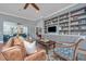 Cozy living room with built-in shelving, comfortable seating, and a ceiling fan at 225 Camber Rd, Huger, SC 29450