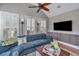 Bright living room with ceiling fan and large sectional sofa with a mounted tv and built-ins at 225 Camber Rd, Huger, SC 29450