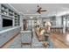 Open-concept living room with hardwood floors, built-in cabinetry, and seamless flow to the kitchen at 225 Camber Rd, Huger, SC 29450