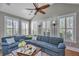 Living area features a large sectional sofa, cathedral ceiling and multiple windows with plantation shutters at 225 Camber Rd, Huger, SC 29450
