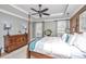 A spacious main bedroom with a four-poster bed, ceiling fan, and plenty of natural light at 225 Camber Rd, Huger, SC 29450