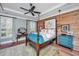 Elegant main bedroom boasts a four-poster bed, wood accent wall and light blue walls at 225 Camber Rd, Huger, SC 29450