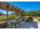 Outdoor patio featuring a dining table, grill, and peaceful view of the lake at 225 Camber Rd, Huger, SC 29450