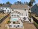 Inviting backyard featuring a hot tub, patio with dining set, and outdoor fireplace perfect for relaxation and entertaining at 225 Waning Way, Charleston, SC 29492