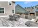 Backyard patio with a brick fireplace, dining area, and comfortable seating, ideal for outdoor gatherings at 225 Waning Way, Charleston, SC 29492