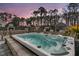 Backyard showing relaxing hot tub, chairs, and a partial view of an outdoor fireplace, creating a perfect retreat at 225 Waning Way, Charleston, SC 29492