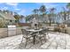 Outdoor patio area with a dining table, grill, fireplace, and comfortable seating, perfect for entertaining at 225 Waning Way, Charleston, SC 29492
