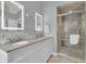 Bright bathroom showcasing a double vanity with granite countertops and a glass-enclosed shower at 225 Waning Way, Charleston, SC 29492