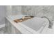 Tranquil bathroom featuring a modern soaking tub with a wooden tray, creating a spa-like retreat at 225 Waning Way, Charleston, SC 29492
