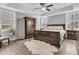 Spacious bedroom featuring a large bed, tray ceiling, ceiling fan and large windows at 225 Waning Way, Charleston, SC 29492