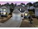 Inviting home featuring a two-car garage, a classic porch, and landscaped front yard at 225 Waning Way, Charleston, SC 29492