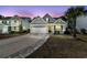Attractive home with a two-car garage, a cozy front porch, and a patterned brick driveway at 225 Waning Way, Charleston, SC 29492