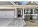 Inviting front porch with white columns, a black door, and a charming walkway at 225 Waning Way, Charleston, SC 29492