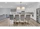 Open kitchen layout with island seating, modern lighting, and seamless flow to the living space at 225 Waning Way, Charleston, SC 29492
