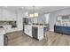 Modern kitchen with stainless steel appliances, a large island with seating, and stylish lighting fixtures at 225 Waning Way, Charleston, SC 29492