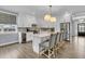 Bright and airy kitchen showcases a center island with seating, stainless appliances, and stylish pendant lighting at 225 Waning Way, Charleston, SC 29492