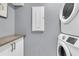 Modern laundry room featuring white washer and dryer, white cabinets with granite counters, and neutral paint at 225 Waning Way, Charleston, SC 29492