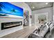 Modern living room features a sleek fireplace, large screen TV, and sliding door access to an outdoor area at 225 Waning Way, Charleston, SC 29492