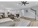 Spacious living area with comfortable seating, a contemporary rug, and easy access to both the kitchen and stairs at 225 Waning Way, Charleston, SC 29492