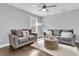 Comfortable living room with a plush grey sofa, modern rug, and natural light, perfect for relaxation at 225 Waning Way, Charleston, SC 29492