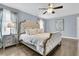 Luxurious main bedroom featuring a stunning bed, hardwood floors, and bright natural light at 225 Waning Way, Charleston, SC 29492
