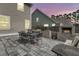 Gorgeous patio features an outdoor dining table and an outdoor brick fireplace, ideal for relaxing and entertaining at 225 Waning Way, Charleston, SC 29492