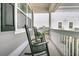 Cozy front porch with rocking chairs and white railings offering a relaxing outdoor space at 225 Waning Way, Charleston, SC 29492