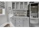 Elegant wet bar featuring gray cabinets, a wine cooler, and stylish backsplash at 225 Waning Way, Charleston, SC 29492