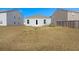 The backyard features a grassy area, with an exterior view of the house at 229 Coral Sunset Way, Summerville, SC 29486