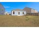 The backyard features a grassy area, with an exterior view of the house at 229 Coral Sunset Way, Summerville, SC 29486
