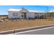 Community clubhouse with well-maintained landscaping, enhancing the neighborhood's appeal at 229 Coral Sunset Way, Summerville, SC 29486