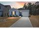 Charming single-story home featuring light blue siding, a one-car garage, and a concrete driveway at 229 Coral Sunset Way, Summerville, SC 29486