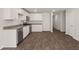 Well-lit kitchen features stainless steel appliances, white cabinets, and modern countertops at 229 Coral Sunset Way, Summerville, SC 29486