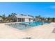 Community pool area with lounge chairs and umbrellas, perfect for summer relaxation at 229 Coral Sunset Way, Summerville, SC 29486