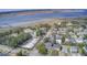 Aerial view of a residential area near a calm body of water with a small pier in the background at 229 Gordon St, Charleston, SC 29403