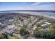 Aerial view of a neighborhood near a body of water, lined with mature trees, sidewalks, and picturesque homes at 229 Gordon St, Charleston, SC 29403