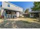 View of the backyard with patio, multiple bikes, landscaping and renovated detached garage at 229 Gordon St, Charleston, SC 29403